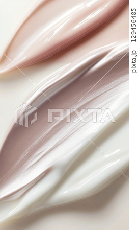 Glossy abstract composition of swirling pearlescent cosmetics cream 129456485
