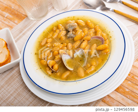 Appetizing clam and bean stew served in plate 129456598