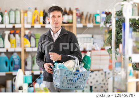 European man with shopping cart goods in supermarket 129456707