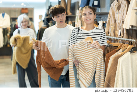 they tried on different jumpers they tried on different jumpers 129456793