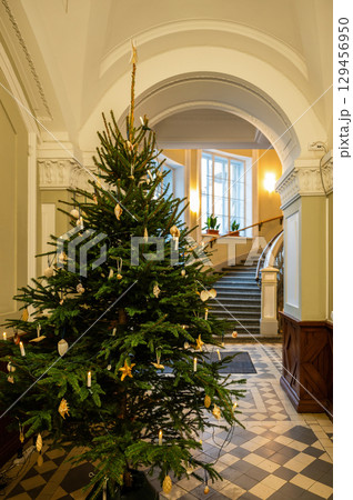 Decorated Christmas tree in elegant building interior with staircase Decorated Christmas tree in elegant building interior with staircase 129456950