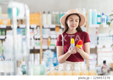 Woman choosing a repellent at the pharmacy 129457270