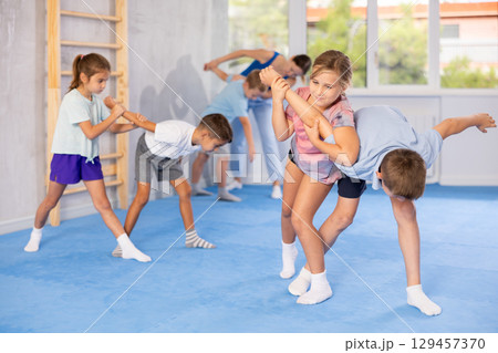 children are working on arm twists children are working on arm twists 129457370