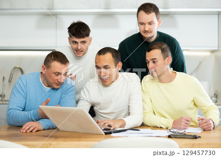 Group of friends communicate via video conference using laptop at home 129457730