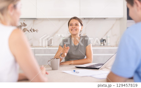 Girl agent agent offers good conditions for insurance or financial loan for spouses in home 129457819