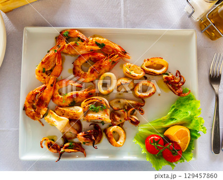 Fried shrimp, octopus and other seafood on plate Fried shrimp, octopus and other seafood on plate 129457860