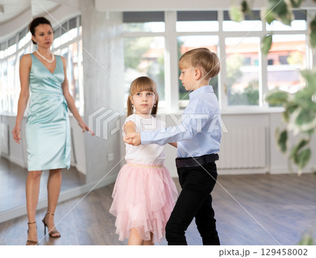 Boy and girl train to dance contemporary vigorous rumba during classes. Boy and girl train to dance contemporary vigorous rumba during classes. 129458002