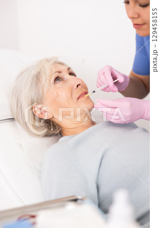 Old woman having mesotherapy procedure on her face Old woman having mesotherapy procedure on her face 129458155