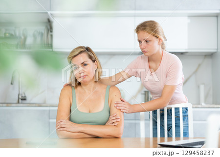 Teenage daughter asking for forgiveness from upset mother 129458237