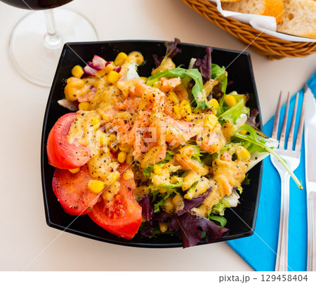 Salad with smoked salmon, tomato, corn, greens Salad with smoked salmon, tomato, corn, greens 129458404
