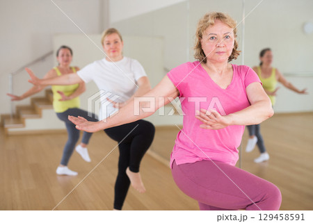 Adult people learning swing steps at dance class 129458591