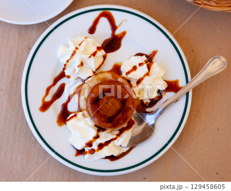 Sweet european dessert flan with whipped cream 129458605