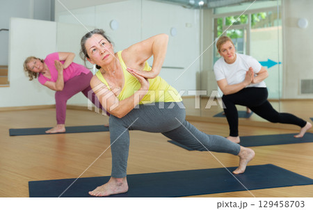 Group lesson on hatha yoga in studio Group lesson on hatha yoga in studio 129458703