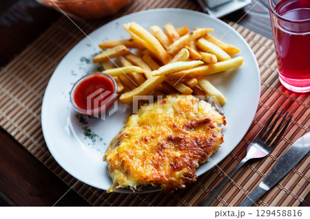 French style meat served with fries and ketchup French style meat served with fries and ketchup 129458816