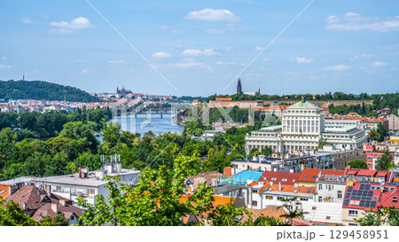 The stunning panorama of Prague showcases the Vltava River flowing through the city. Lush greenery and historical landmarks create an inviting atmosphere on a clear day. The stunning panorama of Prague showcases the Vltava River flowing through the city. Lush greenery and historical landmarks create an inviting atmosphere on a clear day. 129458951