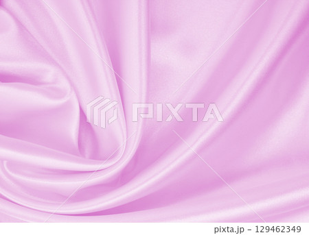 Smooth elegant pink silk or satin texture as wedding background. Luxurious background design 129462349