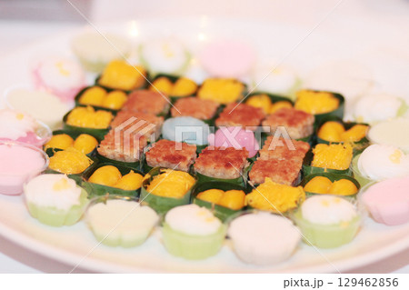 Traditional Thai sweet desserts.Sweet sticky rice with egg custard on top on banana leaves Traditional Thai sweet desserts.Sweet sticky rice with egg custard on top on banana leaves 129462856