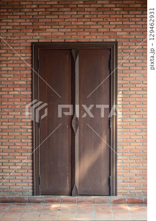 Sunshine through on Antique thai style wooden window on brick wall. Vintage concept. 129462931