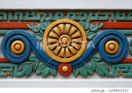 Colorful bas relief showing decorative wheel, spirals, and leaves 129463323