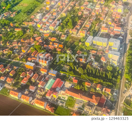 Aerial view of suburban neighborhood with houses and apartment buildings. Urban development, land use, and architectural variety in residential planning. 129463325