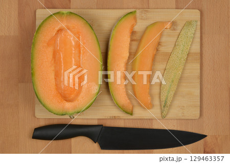 Cutting cantaloupe melon Cutting cantaloupe melon 129463357
