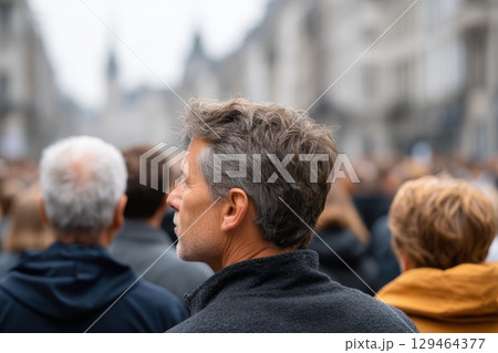 Gray Haired Man In Dark Jacket At Event Composition With Depth On Overcast Day, Crowd Of People 129464377