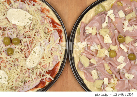 Unbaked pizzas Unbaked pizzas 129465204