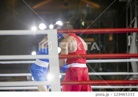 Sparring of two men in a boxing competition Sparring of two men in a boxing competition 129465333