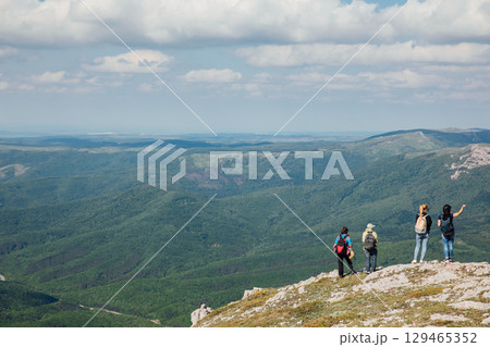 Tourists look at the landscape, mountains and forest 129465352