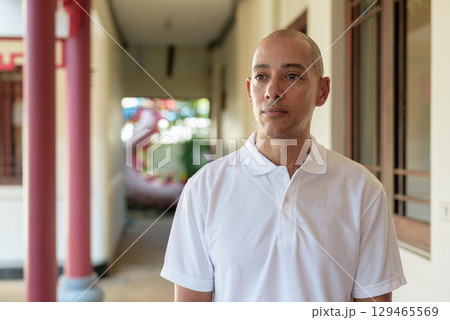Stylish man in white polo shirt posing in tranquil Zen garden portrait Stylish man in white polo shirt posing in tranquil Zen garden portrait 129465569