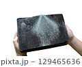 Child holding a broken tablet on his hands on white background 129465636
