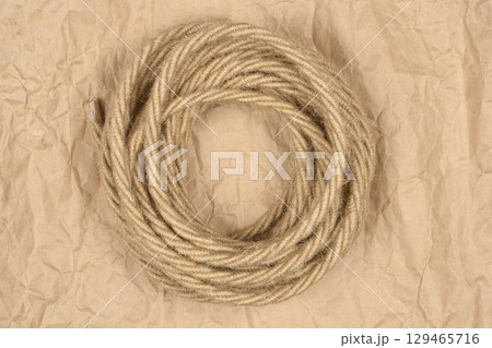Coil of electrical cable wrapped in natural jute twine 129465716