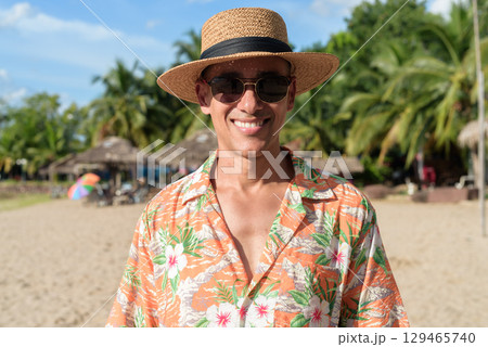 Hispanic Male Tourist in Panama Hat and Tropical Shirt Enjoying Summer Vacation at Beach 129465740