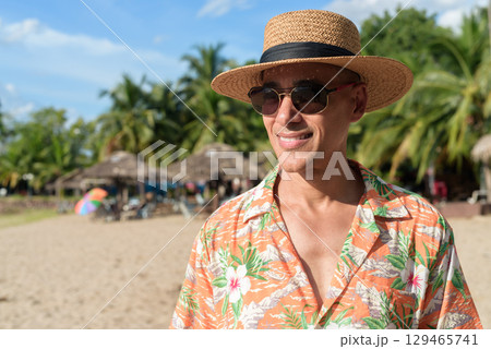 Hispanic Male Tourist in Panama Hat and Tropical Shirt Enjoying Summer Vacation at Beach 129465741
