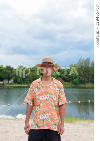 Hispanic Male Tourist in Panama Hat and Tropical Shirt Enjoying Summer Vacation at Beach 129465757