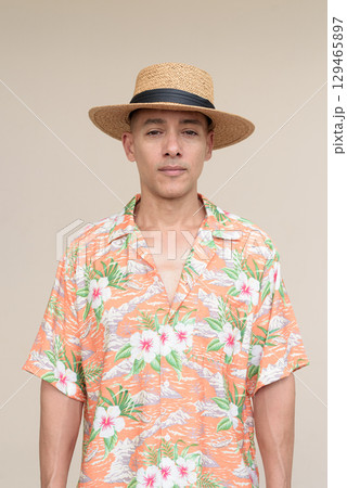 Smiling Hispanic Tourist Man Wearing Panama Hat and Tropical Hawaiian Shirt in Summer Fashion Smiling Hispanic Tourist Man Wearing Panama Hat and Tropical Hawaiian Shirt in Summer Fashion 129465897