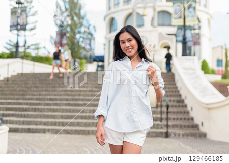 Young Asian woman tourist with long black hair in European style town in portrait travel style Young Asian woman tourist with long black hair in European style town in portrait travel style 129466185