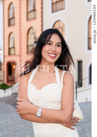 Young Asian woman tourist with long black hair in European style town in portrait travel style Young Asian woman tourist with long black hair in European style town in portrait travel style 129466193