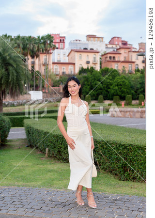 Young Asian woman tourist with long black hair in European style town in portrait travel style Young Asian woman tourist with long black hair in European style town in portrait travel style 129466198