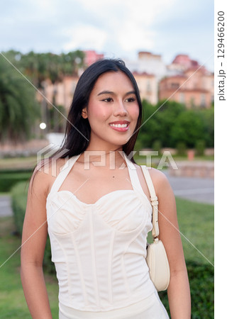 Young Asian woman tourist with long black hair in European style town in portrait travel style 129466200
