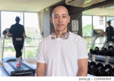 Confident bald Hispanic man posing in gym, fitness and strength-focused lifestyle portrait Confident bald Hispanic man posing in gym, fitness and strength-focused lifestyle portrait 129466964