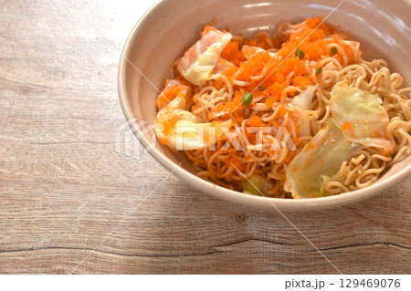 fried instant yellow noodles and cabbage with carrot topping shrimp egg on bowl fried instant yellow noodles and cabbage with carrot topping shrimp egg on bowl 129469076