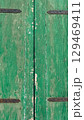 Green weathered wooden door in a quaint Croatian village revealing local charm and rustic beauty 129469411