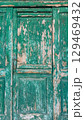Weathered wooden door in Croatia showcasing rustic charm and vibrant colors of historical architecture 129469432