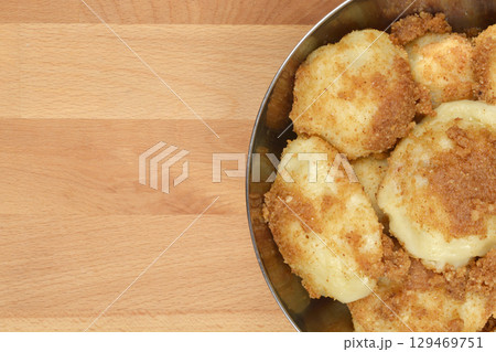Potato dumplings topped with toasted breadcrumbs Potato dumplings topped with toasted breadcrumbs 129469751