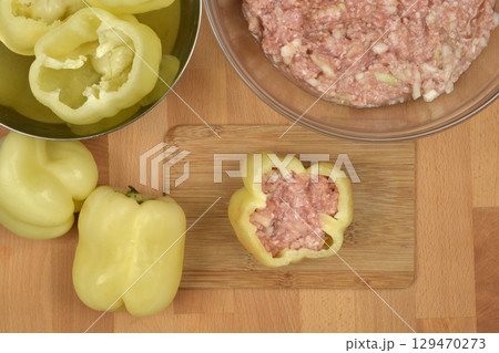Raw pepper being stuffed 129470273