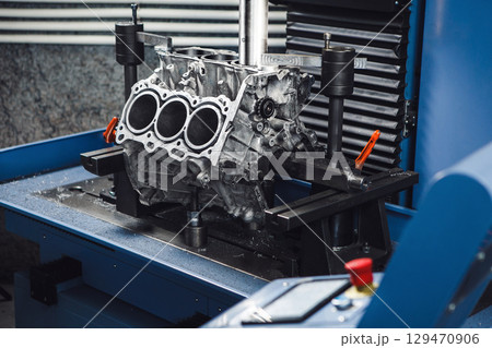 Three-cylinder engine repair on CNC machine, boring under the piston using machine with Computer Numerical Control. Three-cylinder engine repair on CNC machine, boring under the piston using machine with Computer Numerical Control. 129470906