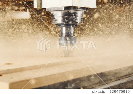 Cnc machine at carpentry workshop. Cutting wood with various router bits. Cnc machine at carpentry workshop. Cutting wood with various router bits. 129470910