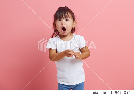 Cute little child looks at the camera in surprise, being struck by unexpected news. An emotional three years old girl expresses surprise, does not believe her eyes. Cute little child looks at the camera in surprise, being struck by unexpected news. An emotional three years old girl expresses surprise, does not believe her eyes. 129471054