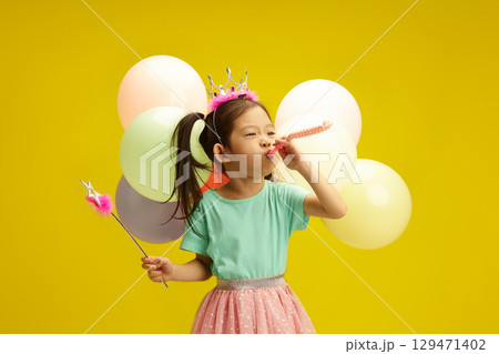 Birthday Girl with Balloons and Party Whistle Funny Celebrating Her Holiday on Yellow Isolated Background Birthday Girl with Balloons and Party Whistle Funny Celebrating Her Holiday on Yellow Isolated Background 129471402